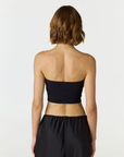Elevate your warm-weather wardrobe with the Edie Bandeau Top from AOCO. This chic strapless design offers a flattering fit and endless style possibilities.