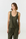 A woman modeling a sleeveless scoop-neck tank top and matching drawstring pants in olive green, photographed against a clean light gray studio background.