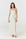 A woman modeling a strapless, floor-length white maxi dress against a plain white studio background.