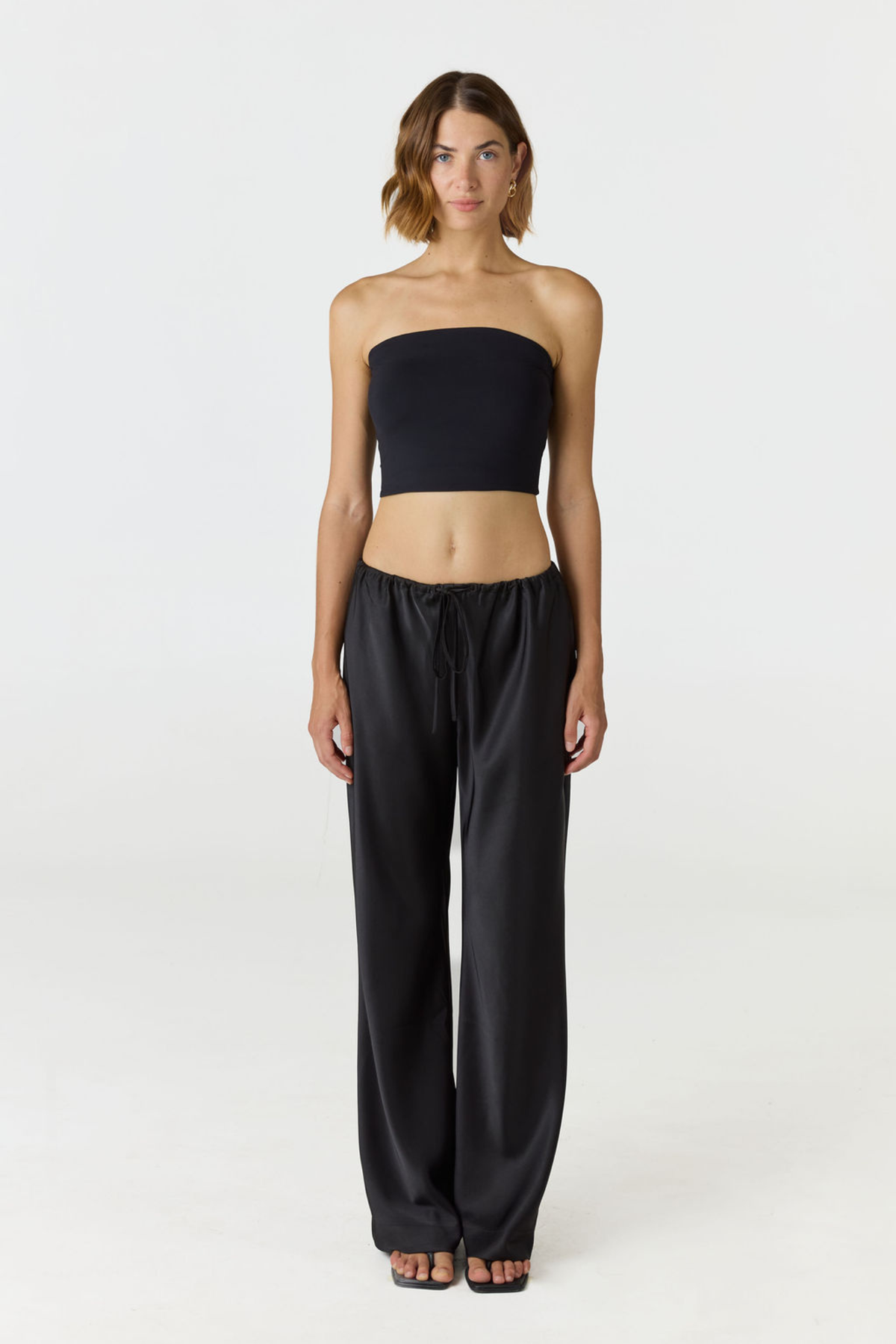 Elevate your warm-weather wardrobe with the Edie Bandeau Top from AOCO. This chic strapless design offers a flattering fit and endless style possibilities.
