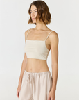 Elevate your everyday style with the Isla Cropped Tank by AOCO. Featuring a flattering fit and breathable fabric, it's the perfect warm weather staple.